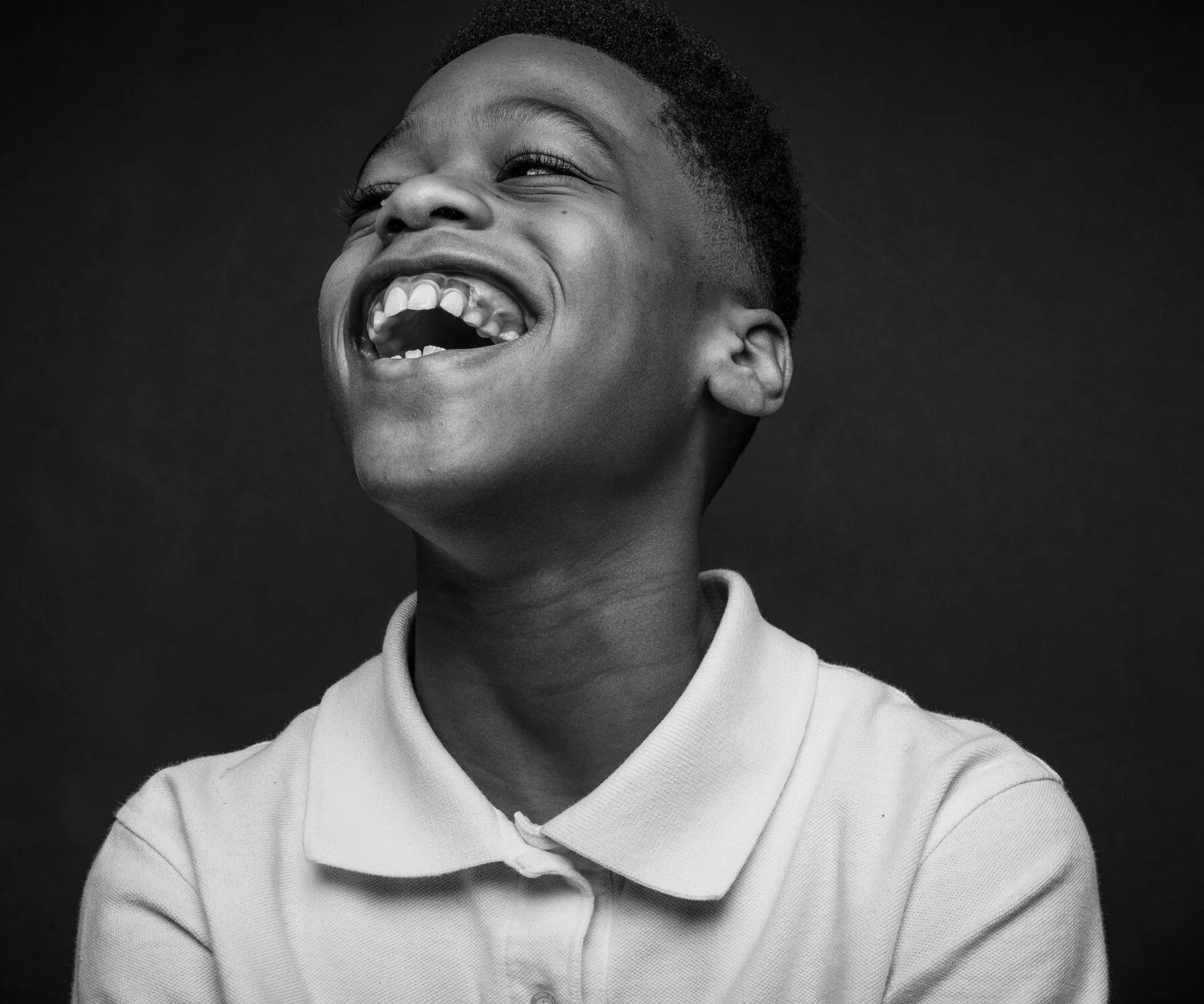 A young man of Black Boys 2 Men, mid-laugh